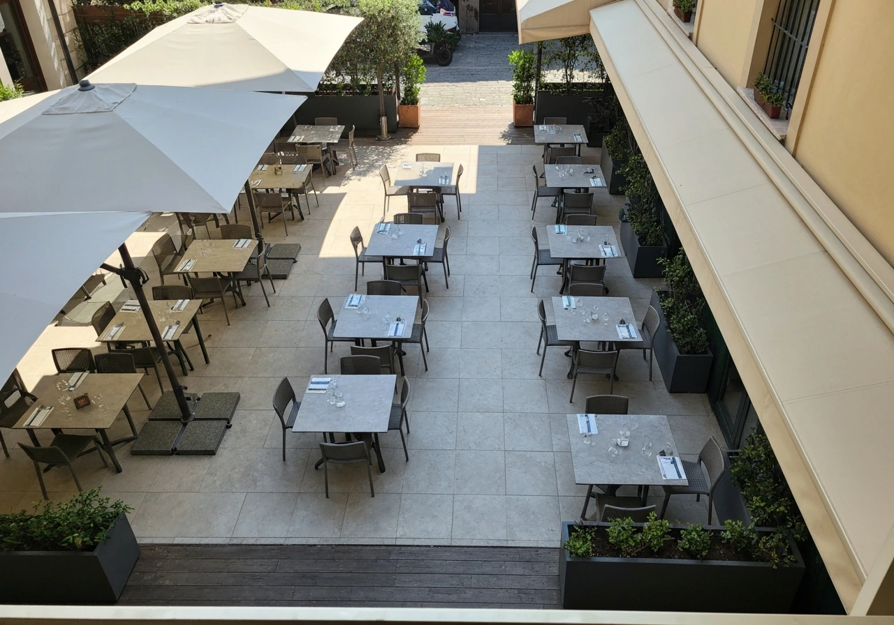 Angled view of an empty patio layout showing spacious table spacing and covered vs uncovered areas.