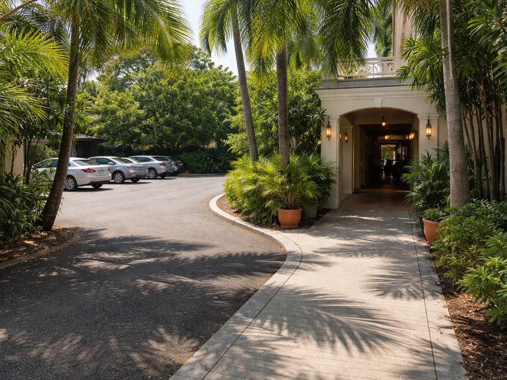 Quiet San Juan sidewalk route from an off-site parking lot toward a hotel walkway entrance approach.