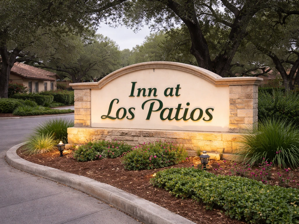 Exterior storefront of a San Antonio senior living property showing an Inn at Los Patios style sign.