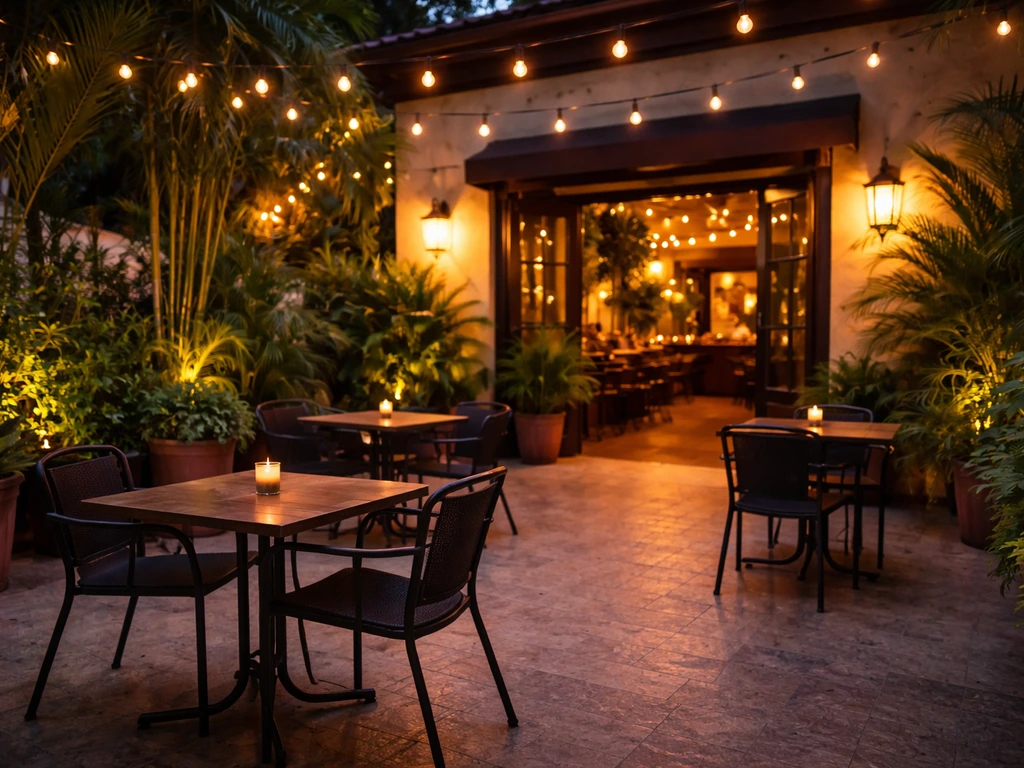 Outdoor view of a Dominican restaurant patio with warm lighting, plants, and casual seating in Newport News.