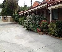 Exterior view of El Patio Inn in Studio City, showing the motel building and driveway